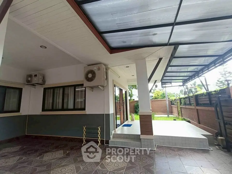 Spacious covered patio with garden view and modern design