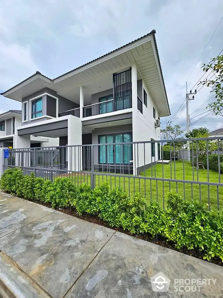 Modern two-story house with spacious garden and sleek exterior design