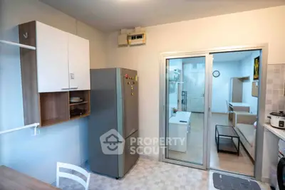 Modern kitchen with open layout and sleek appliances in a cozy apartment.