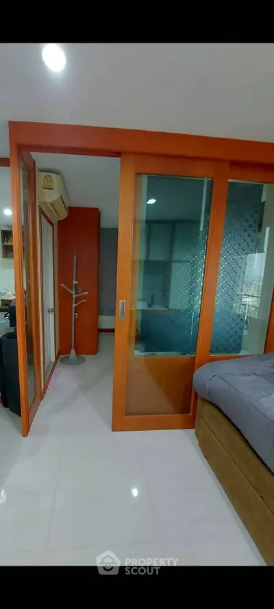 Modern bedroom with sliding glass doors and air conditioning unit