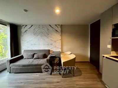 Modern living room with stylish marble accent wall and cozy seating area