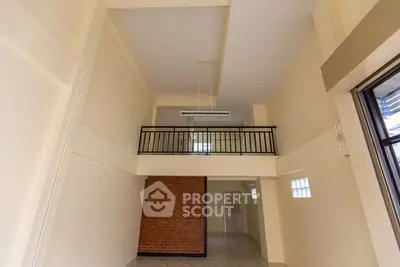 Spacious loft interior with high ceilings and brick accent wall