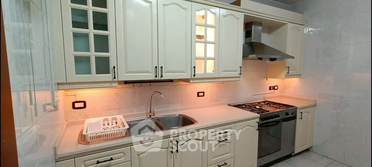 Spacious kitchen with modern appliances and ample storage space