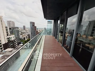 Stunning high-rise balcony with panoramic city views and modern glass railing.