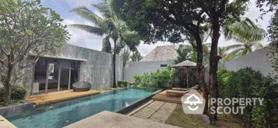 Luxurious private villa with pool and lush garden, perfect tropical retreat.