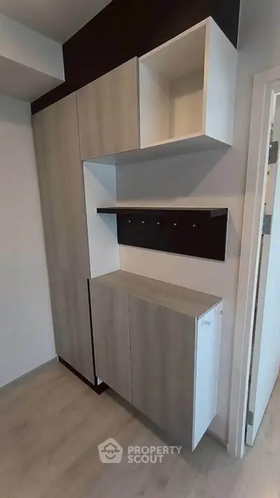 Modern storage unit with sleek wooden finish in contemporary apartment.