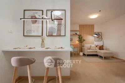 Modern open-plan living room with stylish decor and cozy seating area.