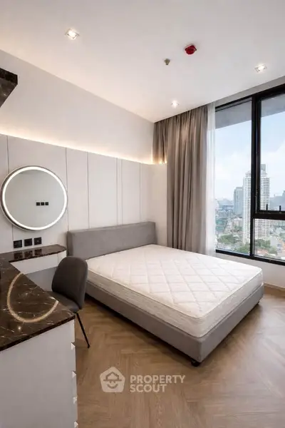 Modern bedroom with city view, featuring sleek design and elegant furnishings.