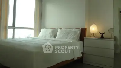 Modern bedroom with large window and stylish lamp