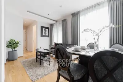 Elegant living room with dining area, featuring modern furniture and abundant natural light.