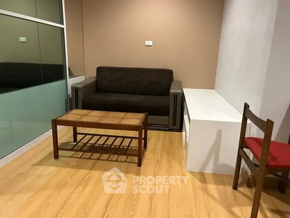 Cozy living room with modern sofa and wooden coffee table, perfect for relaxation.
