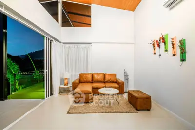 Modern living room with leather sofa and open balcony view
