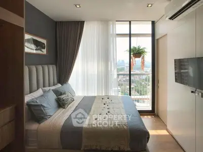 Modern bedroom with large window and city view, featuring stylish decor and cozy ambiance.