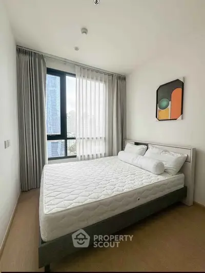 Modern bedroom with large window and stylish decor in urban apartment