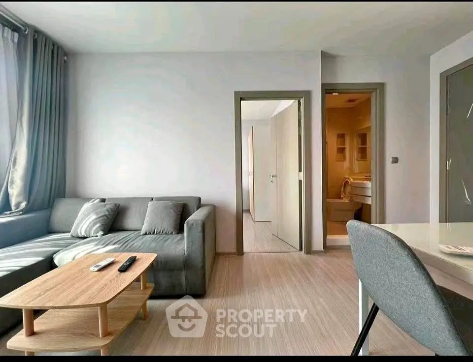 Modern living room with cozy gray sofa and sleek wooden coffee table