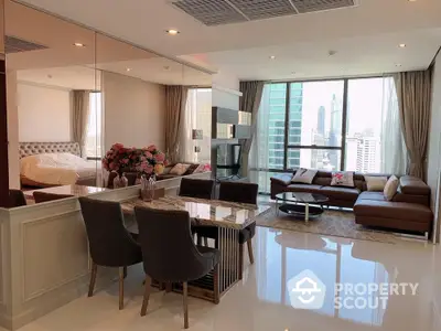 Luxurious open-plan living room with city view, modern furniture, and elegant decor in high-rise apartment.