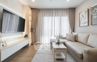 Modern living room with stylish decor and large TV, perfect for relaxation.