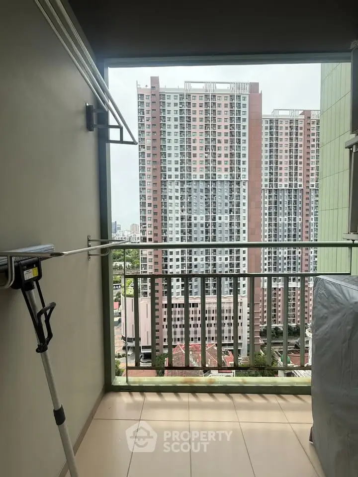 High-rise apartment balcony with cityscape view, perfect for urban living.