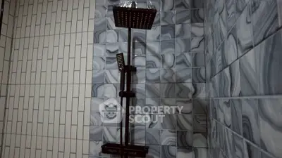 Modern bathroom shower with stylish tile design and sleek fixtures.
