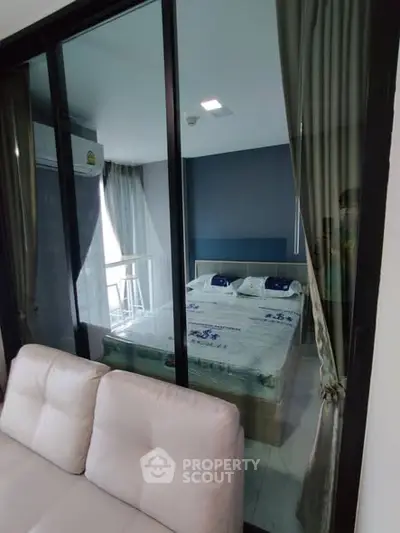 Modern bedroom with glass partition and stylish decor in a contemporary apartment.