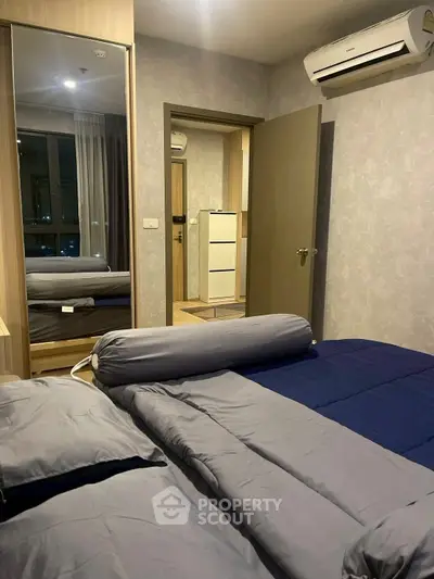 Cozy bedroom with modern decor and air conditioning in a stylish apartment.