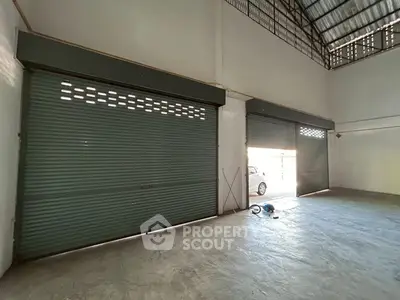 Spacious industrial warehouse with large roller doors and high ceilings for versatile use.