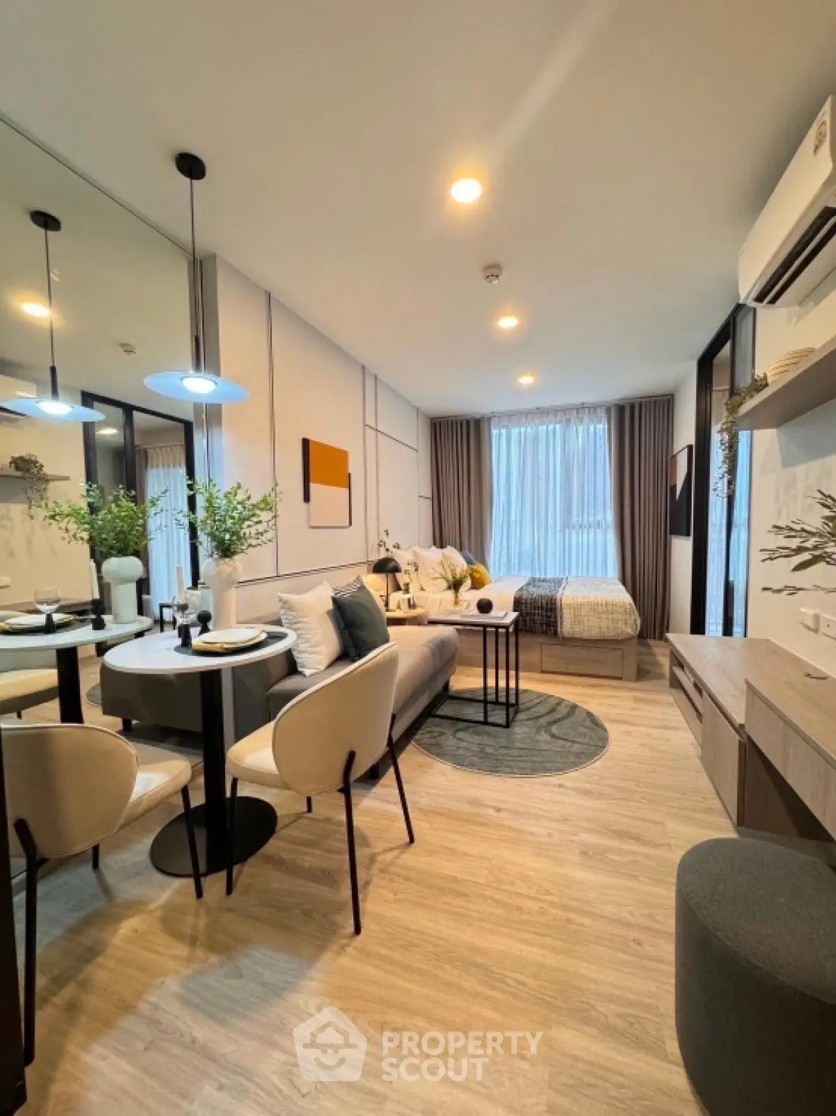 Modern studio apartment with stylish decor and open layout, featuring cozy living and dining area.