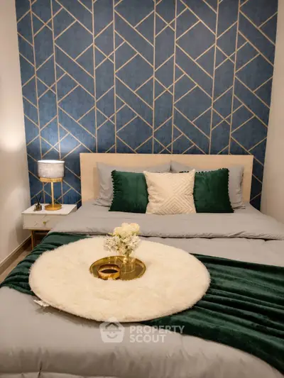 Stylish bedroom with geometric accent wall and cozy decor