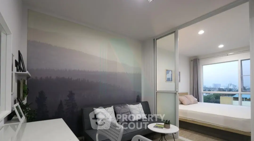 Modern studio apartment with stylish living area and cozy bedroom, featuring a scenic wall mural and large window view.