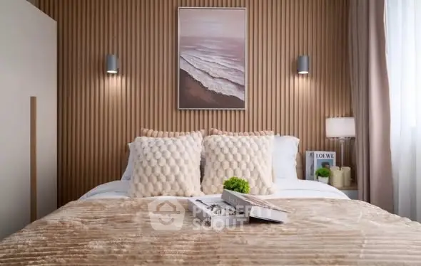 Luxurious bedroom with elegant decor and cozy ambiance, featuring plush bedding and stylish wall art.