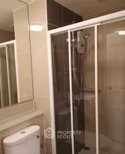 Modern bathroom with sleek shower enclosure and contemporary fixtures.