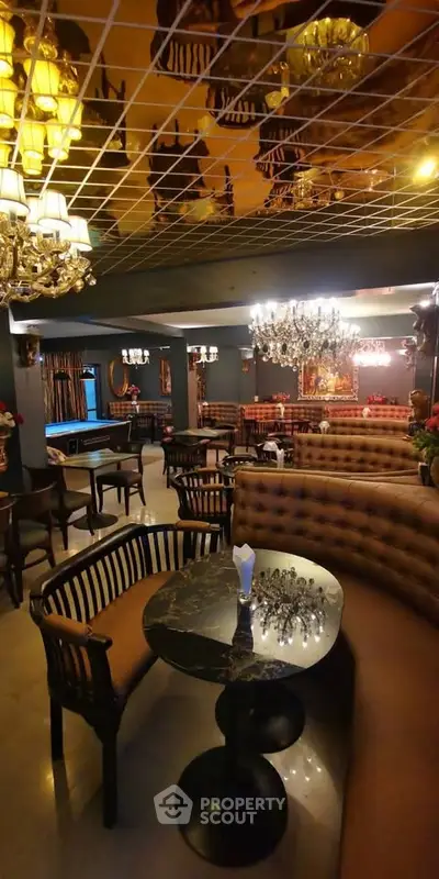Luxurious lounge area with elegant chandeliers and plush seating, perfect for upscale gatherings.