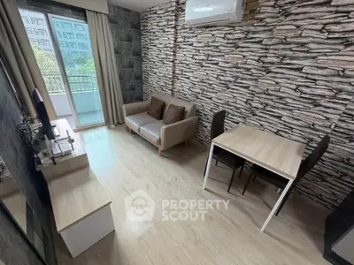 Modern living room with stone accent wall and balcony view in urban apartment