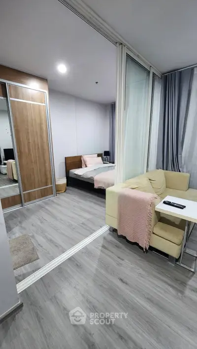 Modern studio apartment with cozy living area and stylish bedroom