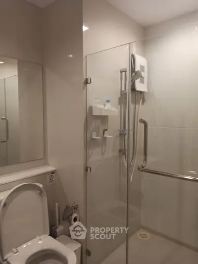 Modern bathroom with glass shower enclosure and sleek fixtures