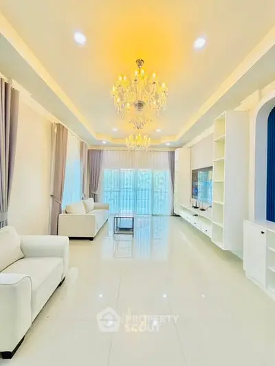 Luxurious living room with elegant chandeliers and modern white decor