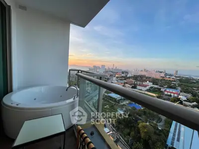 Luxurious balcony with stunning city view and private jacuzzi, perfect for relaxation and enjoying sunsets.