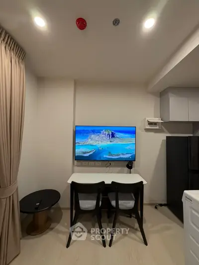 Modern living room with wall-mounted TV and stylish furniture