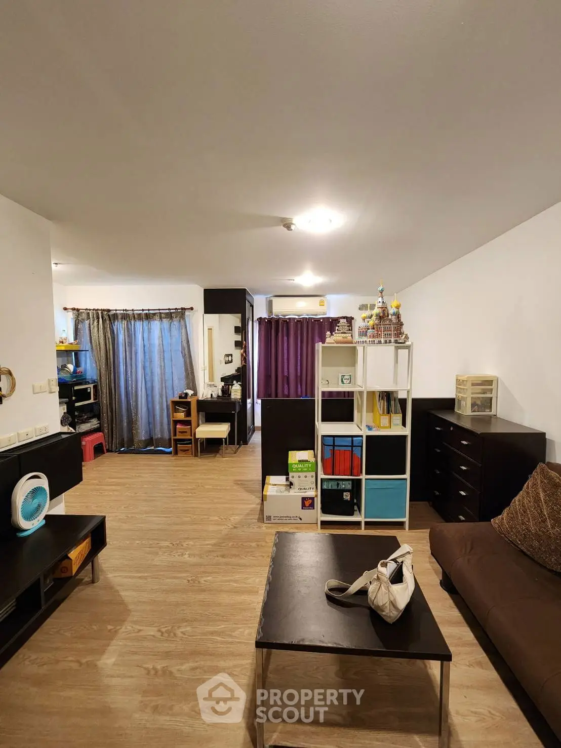 Spacious living room with modern decor and ample natural light