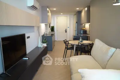 Modern living room with sleek furniture and open kitchen layout