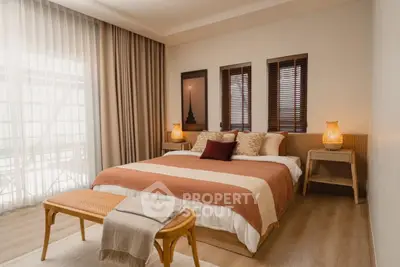 Spacious bedroom with elegant decor and natural light