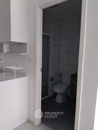 Compact bathroom with modern white tiles and sleek fixtures