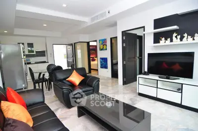 Modern living room with sleek furniture and open kitchen layout