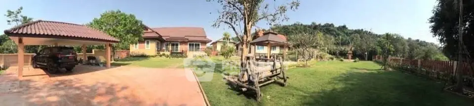 Spacious countryside property with lush garden and carport, perfect for serene living.