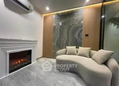 Luxurious living room with modern fireplace and elegant curved sofa