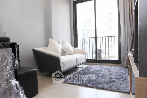 Modern living room with sleek sofa and large window offering city view