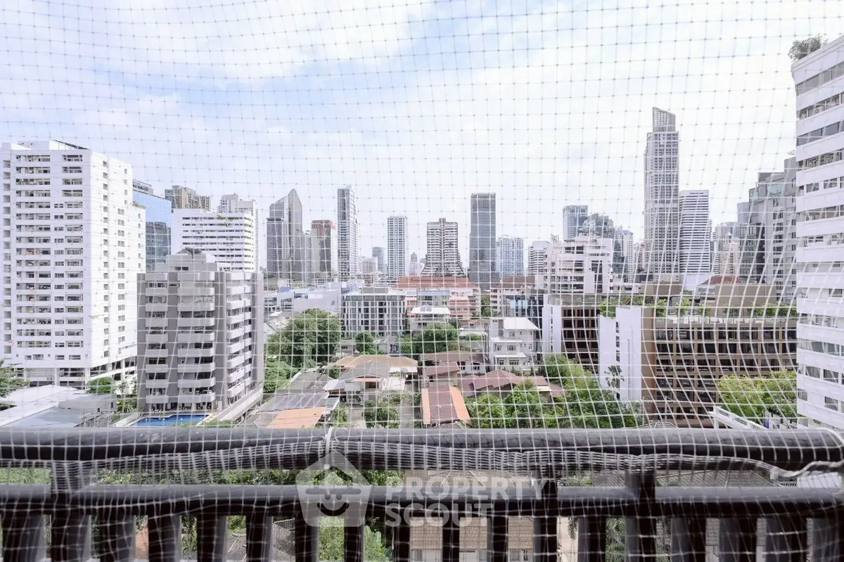 Stunning cityscape view from a high-rise balcony with modern skyscrapers.
