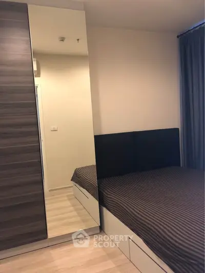Modern bedroom with sleek wardrobe and cozy bed in stylish apartment.