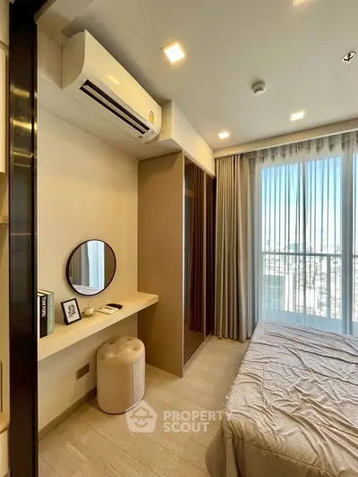 Modern bedroom with city view, featuring a cozy bed, vanity area, and large window for natural light.