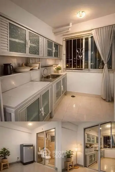 Modern kitchen with sleek cabinets and large window, adjacent to a cozy living area with glass doors.